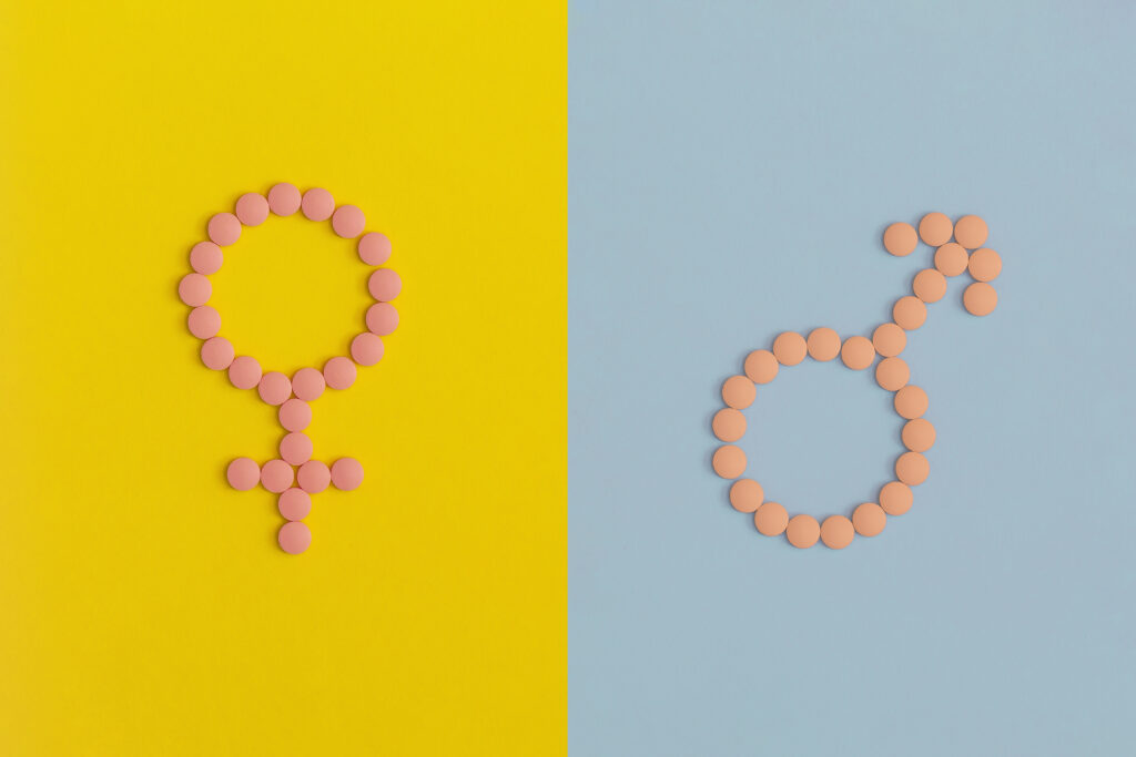 Zeichen für Frauen und Männern auf gelbem bzw. blauem Hintergrund
