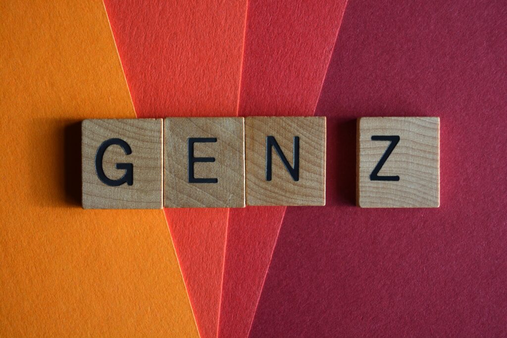 Buchstaben GEN Z auf einem gefächersten Hintergrund in organge, rot und dunkelrot